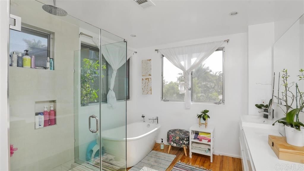 A bathroom with a bathtub and a walk in shower.