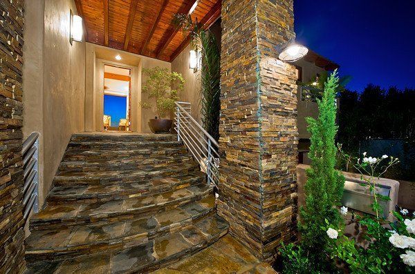 A stone staircase leading up to the entrance of a house.