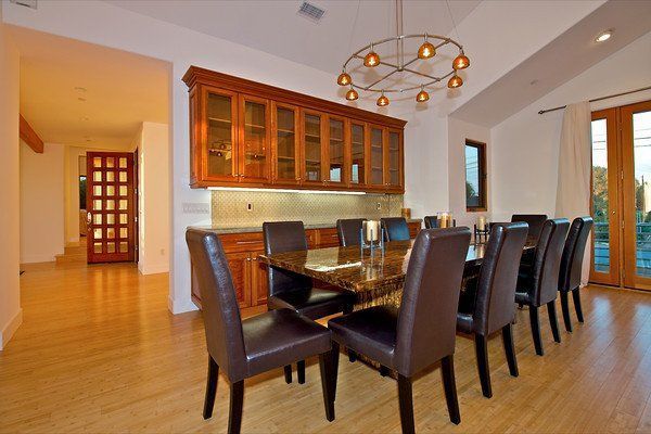 A dining room with a long table and chairs