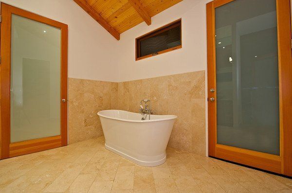 There is a bathtub in the middle of the bathroom in a newly remodeled home in San Diego, California.
