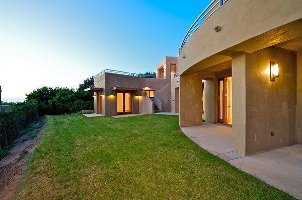A large house in San Diego County with a large lawn in front of it