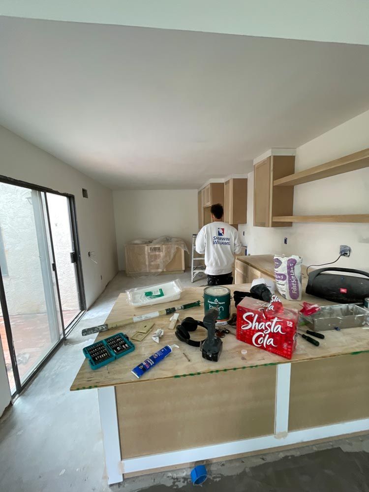 A man is working on a kitchen in a house under construction in San Diego, California.