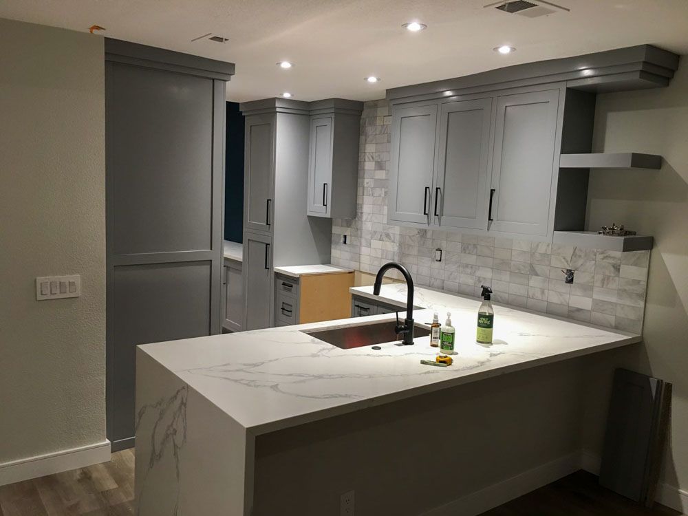 A kitchen with a large island and a sink.