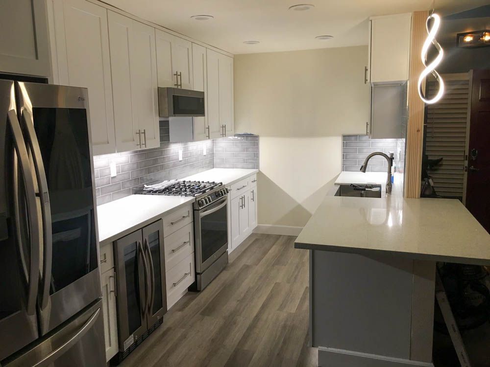 A kitchen with white cabinets and stainless steel appliances.