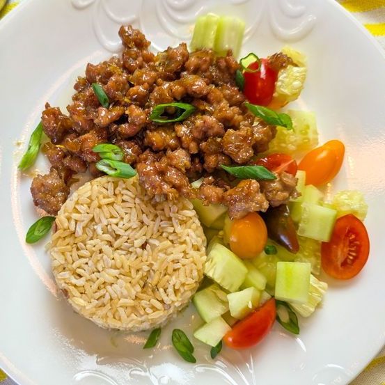 Caramelized Pork Bowls over Organic Della Basmati Light Brown Rice Cucumber Tomato Salad