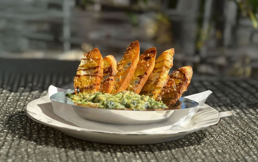 Artichoke dip with toasted bread slices.