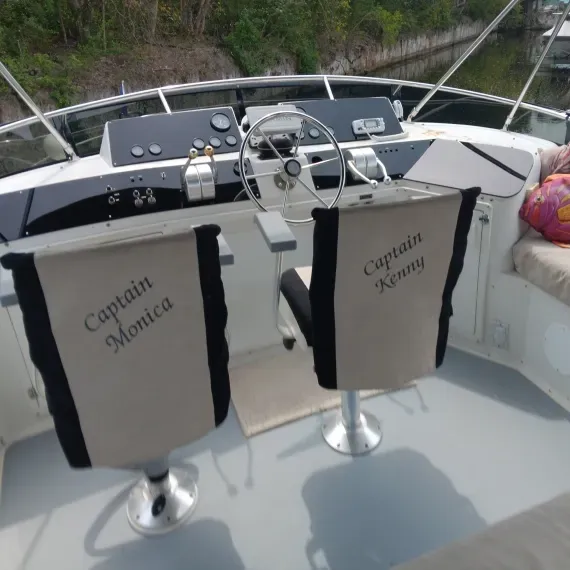 Boat's helm with two captain chairs labeled 