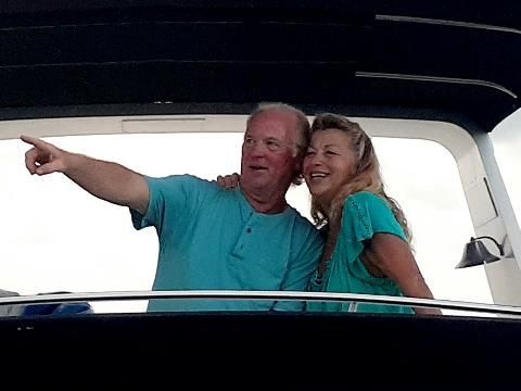 Person snorkeling, giving thumbs up in clear turquoise water.