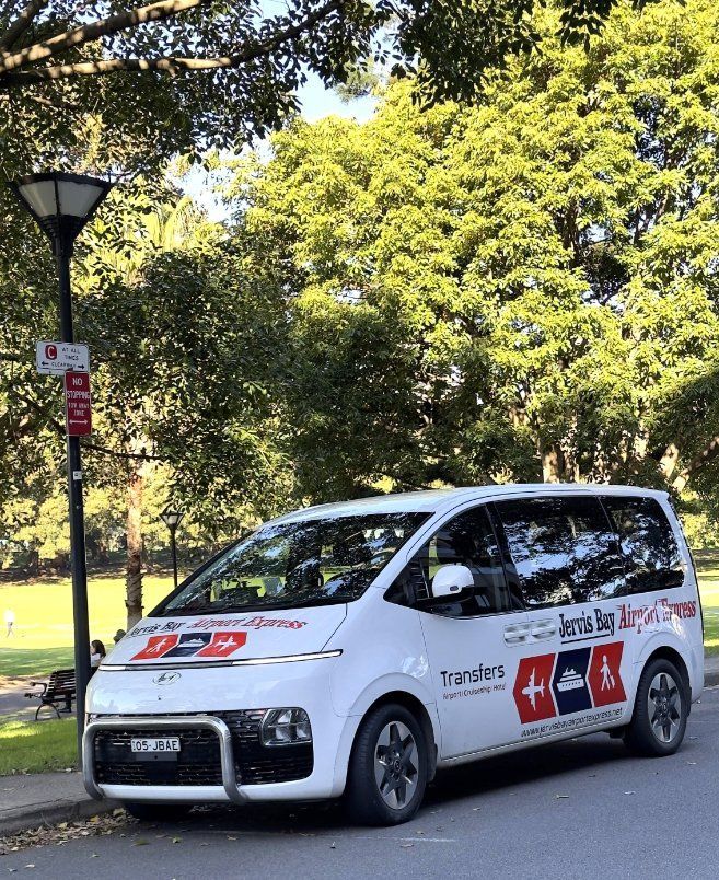 A Black Van Is Parked In A Parking Lot — Jervis Bay Airport Express In Swanhaven, NSW