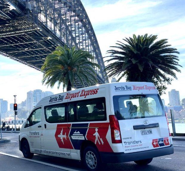 A Row Of Black Vans Parked Next To Each Other In A Parking Lot — Jervis Bay Airport Express In Swanhaven, NSW