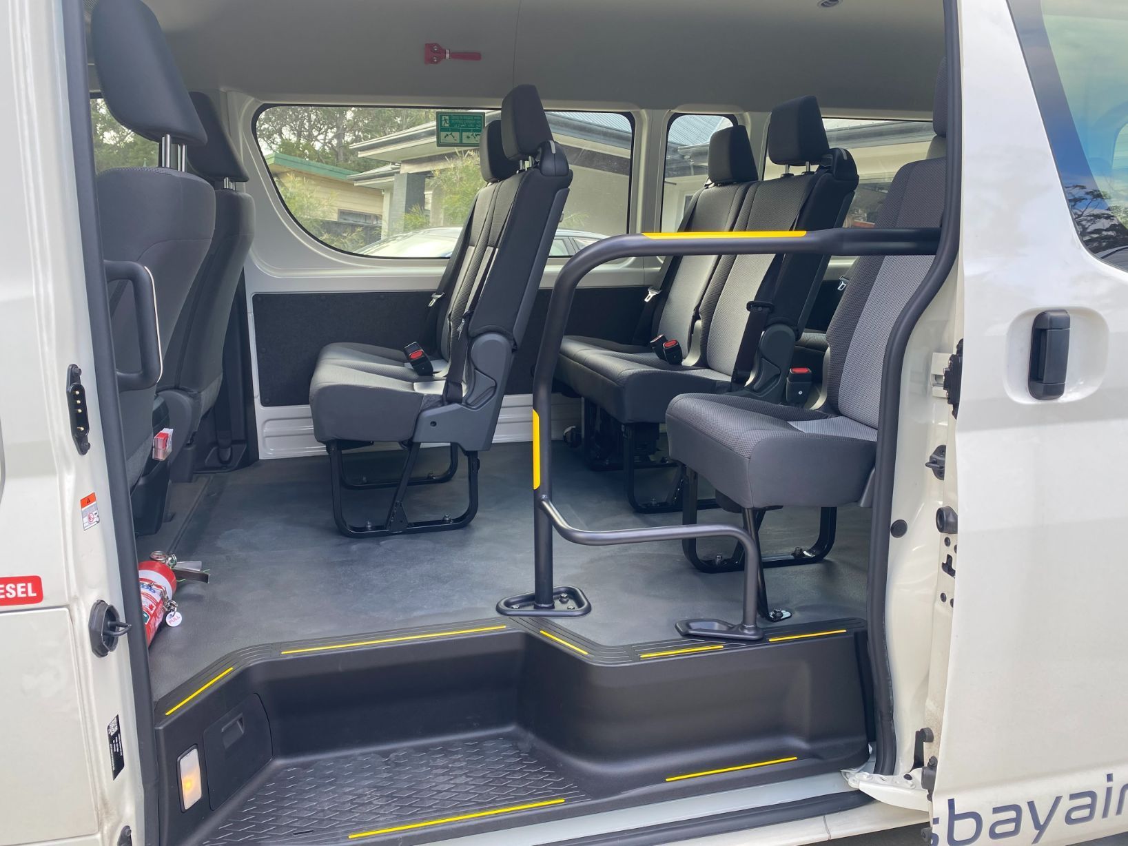 A Man Is Standing Next To Two Suitcases At An Airport — Jervis Bay Airport Express In Swanhaven, NSW