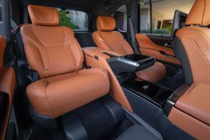 The interior of a car with brown leather seats.