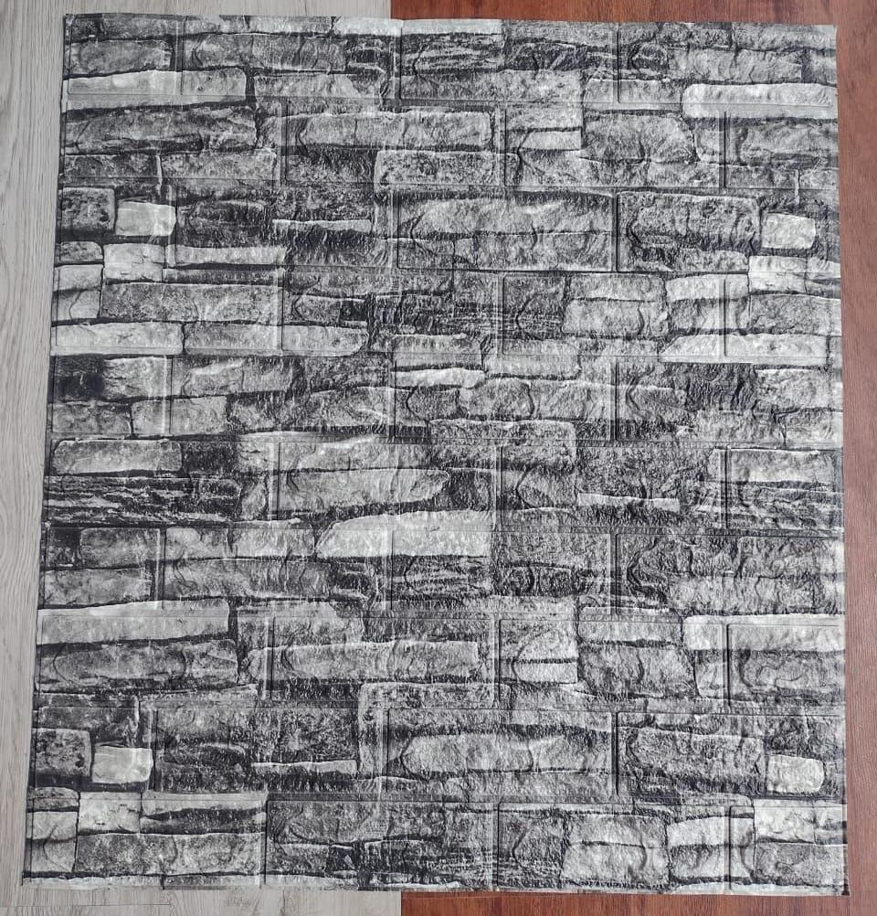 Un trozo de papel tapiz que parece una pared de ladrillos está colocado sobre un piso de madera.