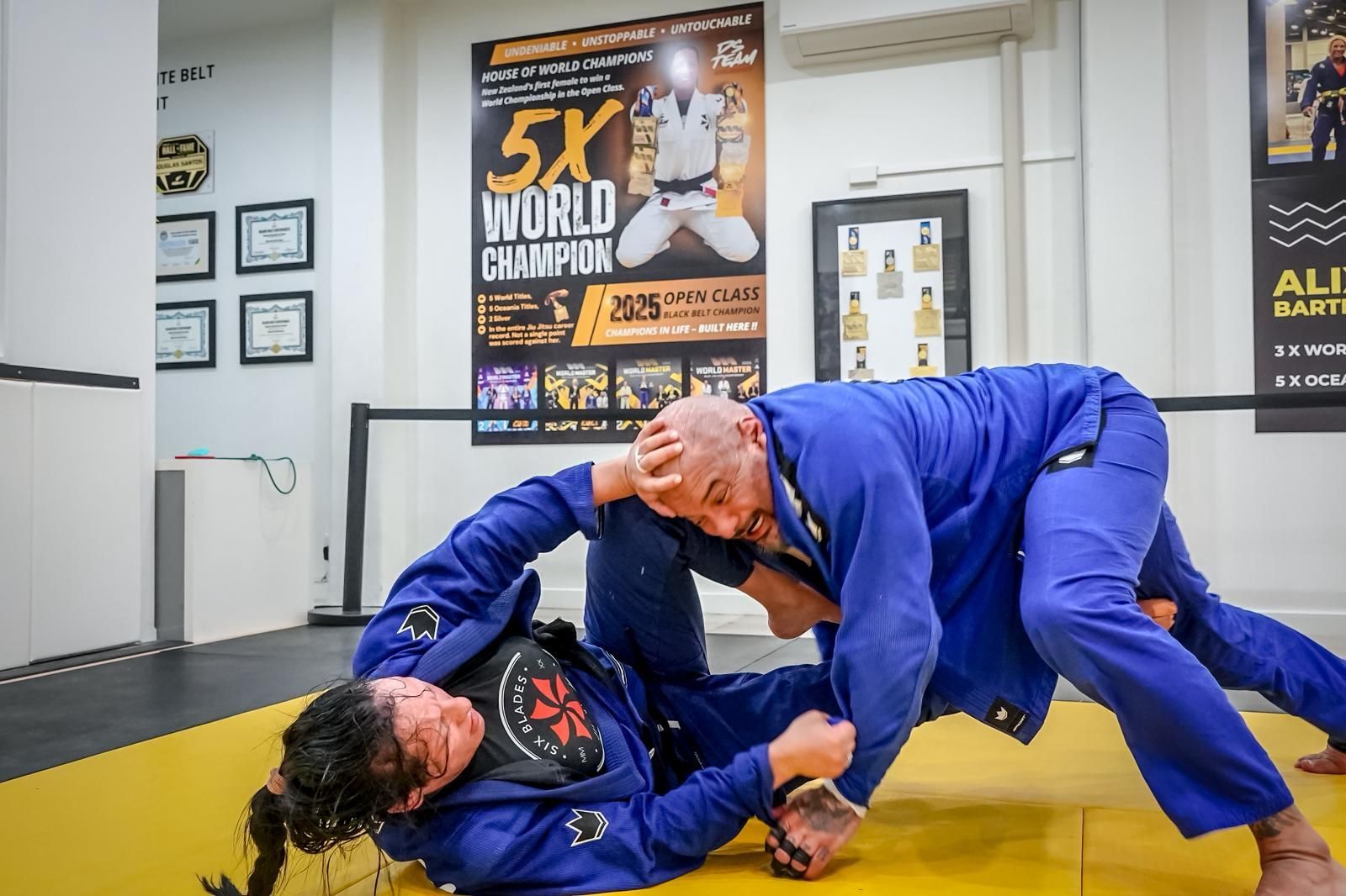 Competition team athlete mid-technique at tournament
