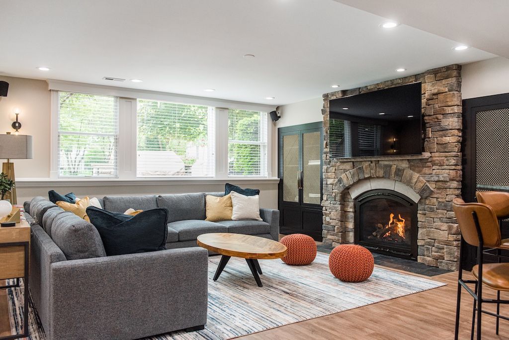 Modern living room with fireplace, gray sofa, and wooden coffee table.
