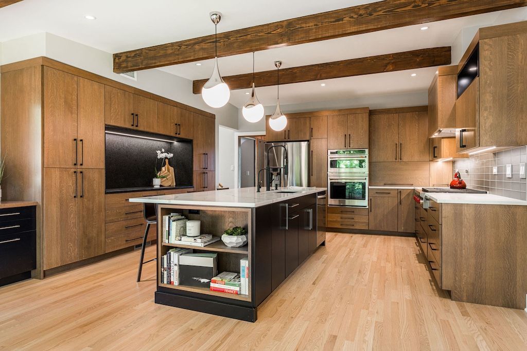 Modern kitchen with wood cabinets, island, and ceiling beams.