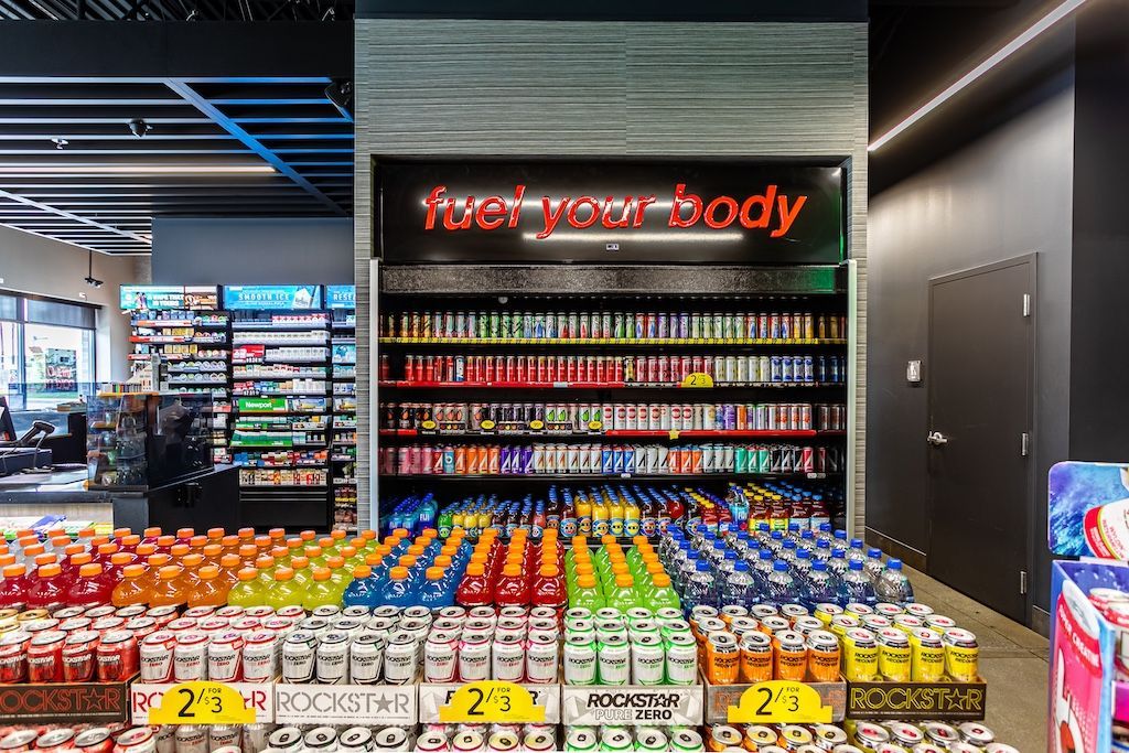 Interior shot of a store beverage display with a neon sign: 