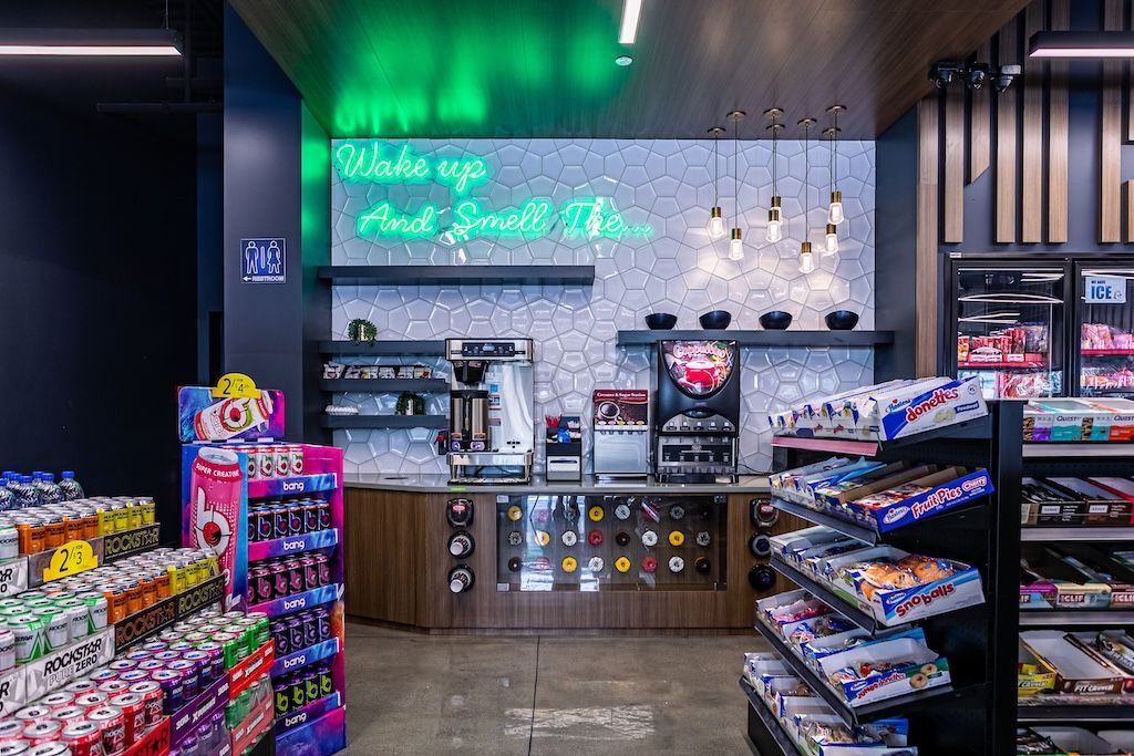 Interior of a convenience store with neon sign that says 