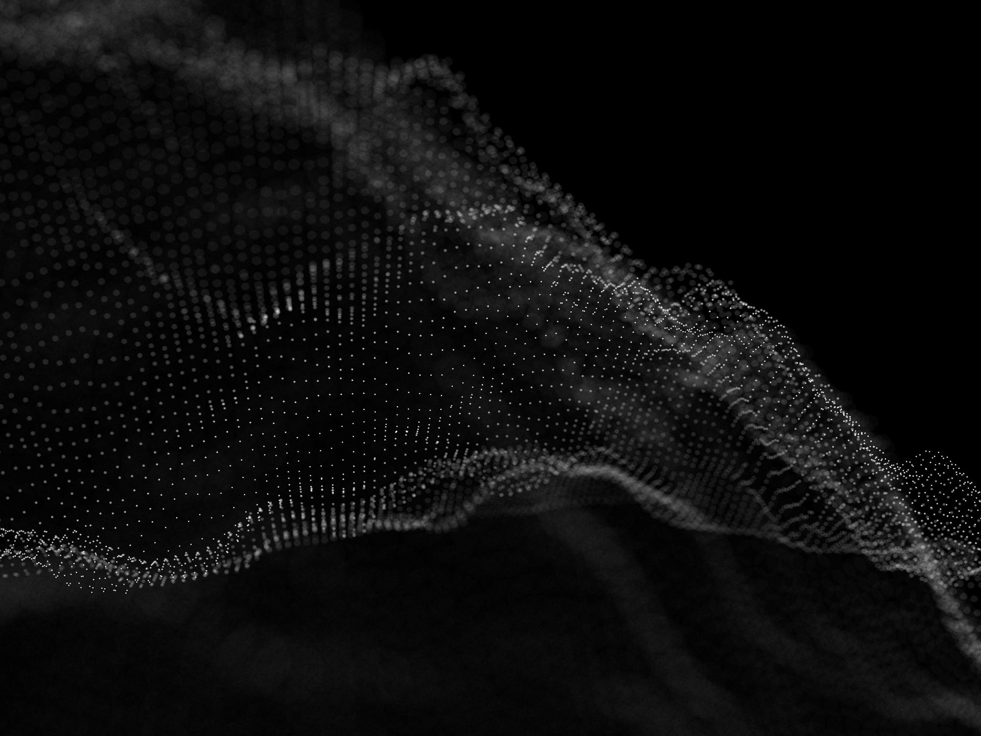 A black and white image of a wave of particles on a black background.