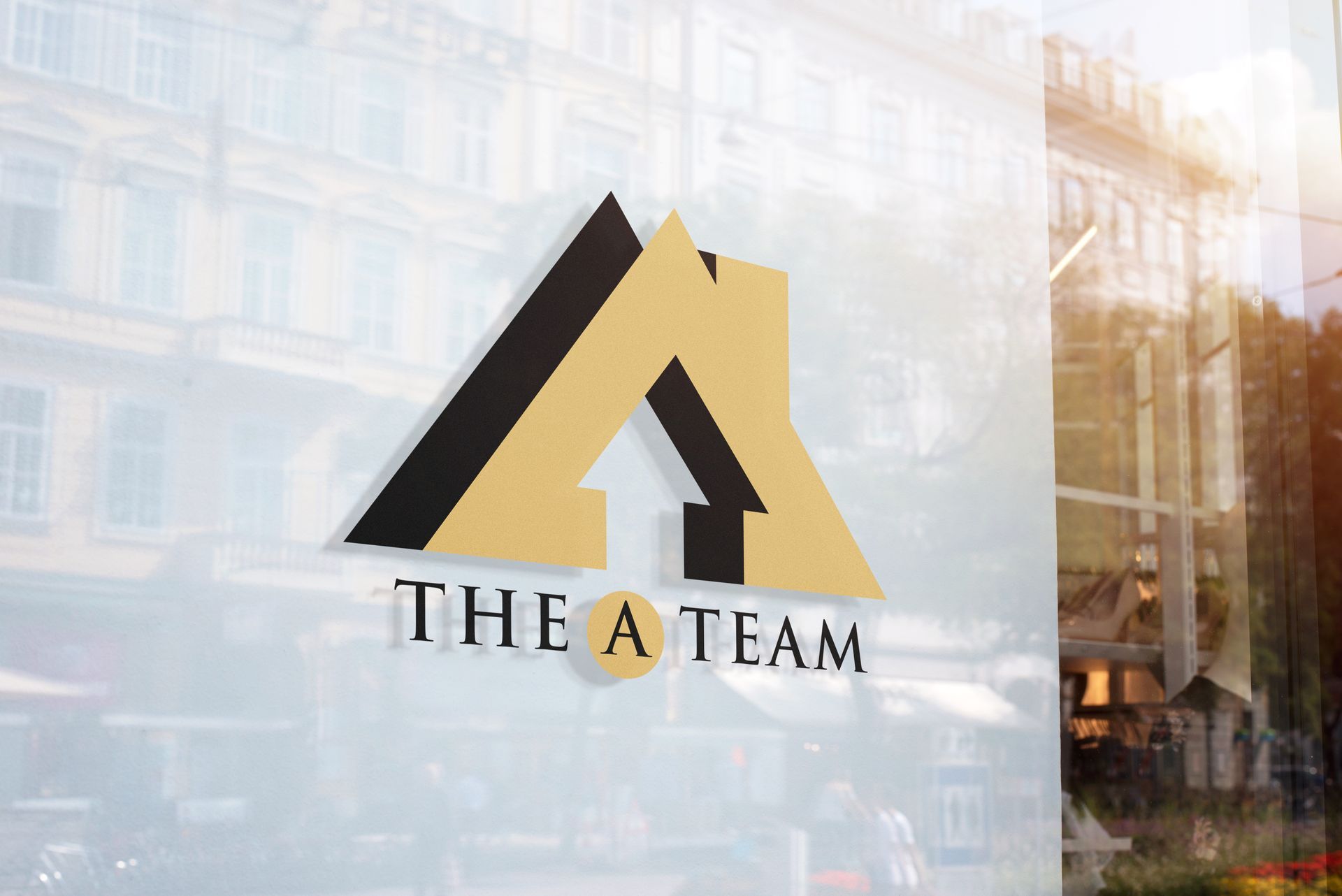 A logo for The A Team Realtors on a glass window.