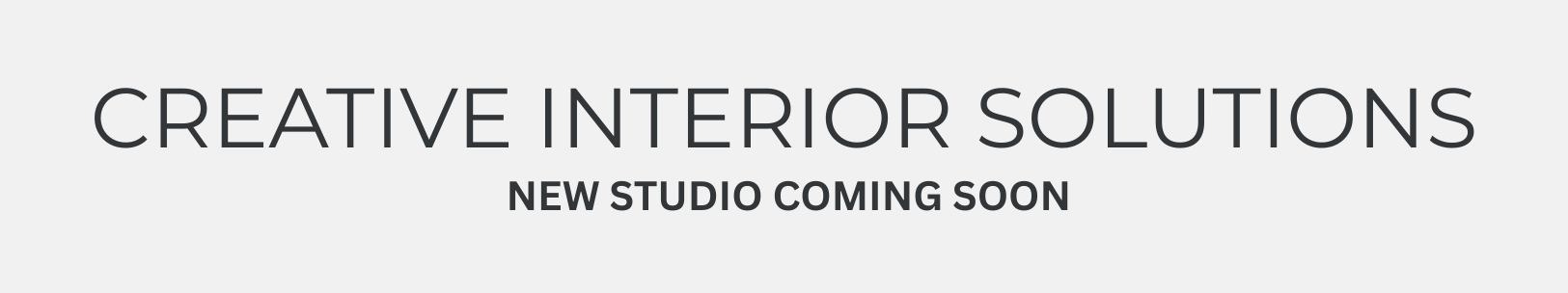 Logo for Creative Interior Solutions, featuring a head-shaped icon with a lightbulb, and text: