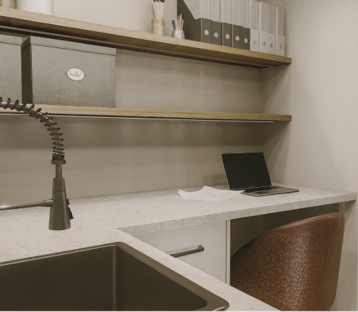 A room with a wooden dresser, arched mirror, and a doorway leading to a bedroom with a view. Green and gold color scheme.