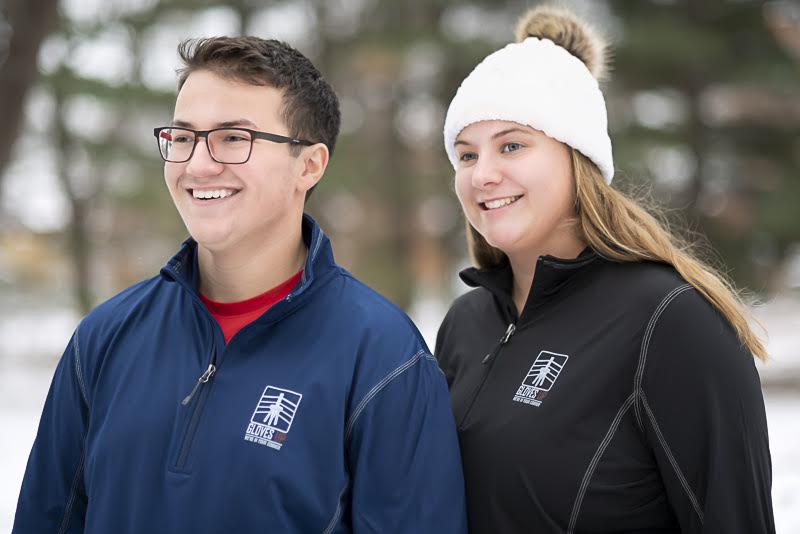 A man and woman both wearing Gloves Up apparel