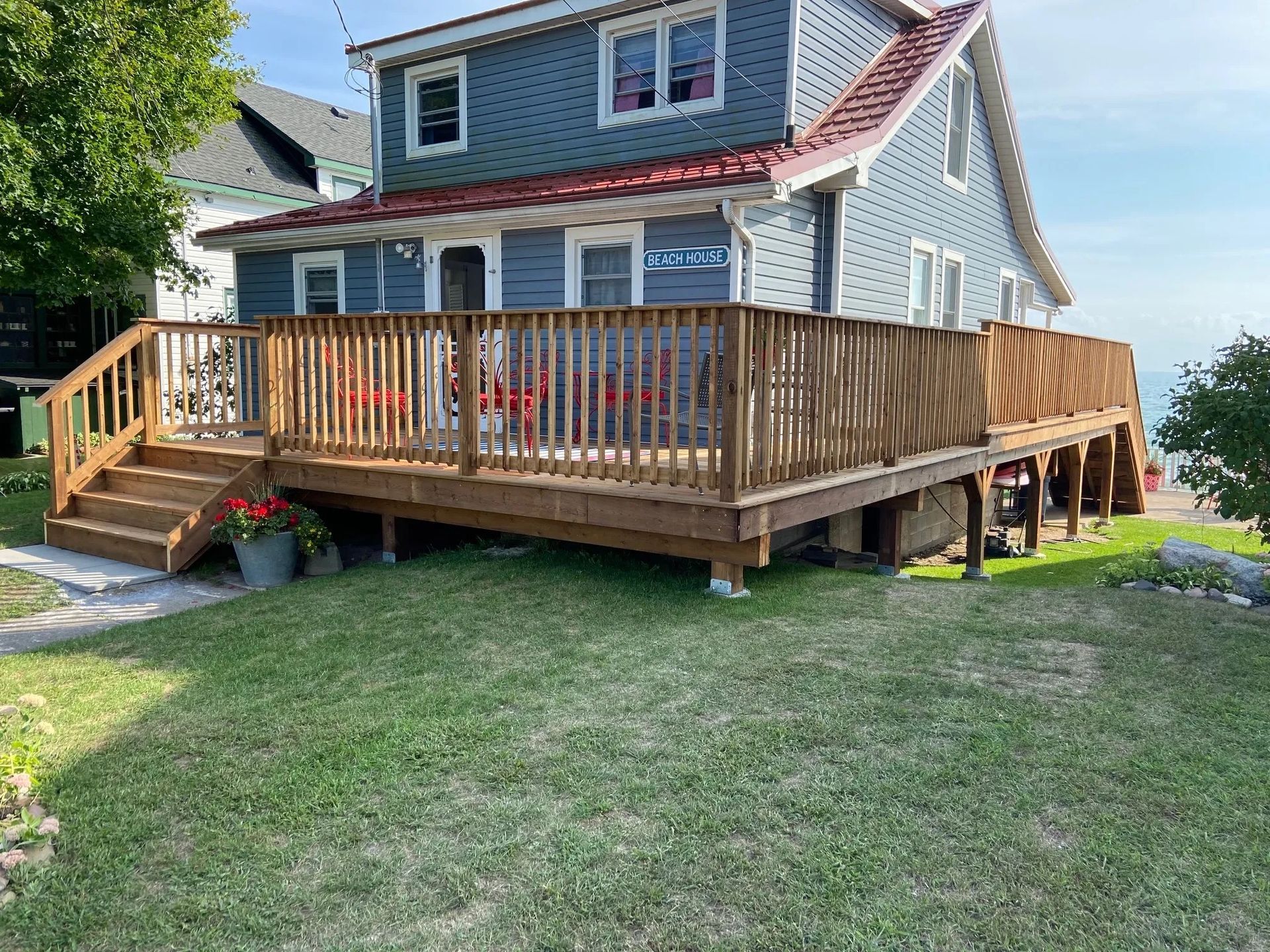 A large house with a large wooden deck in front of it.