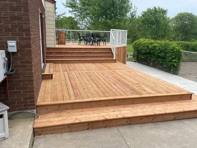 A wooden deck with stairs leading up to it