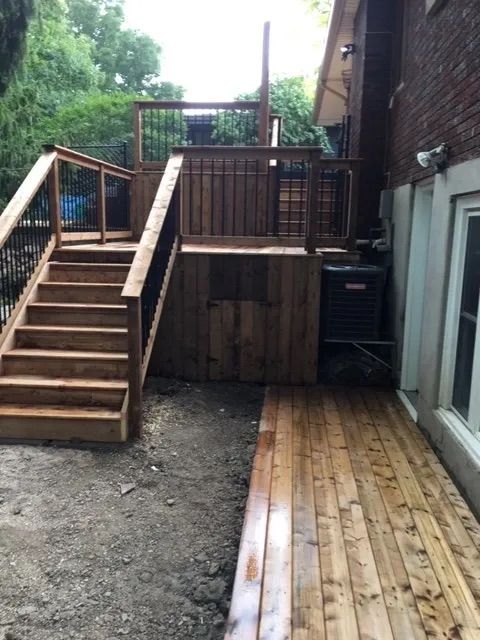 A wooden deck with stairs leading up to it.