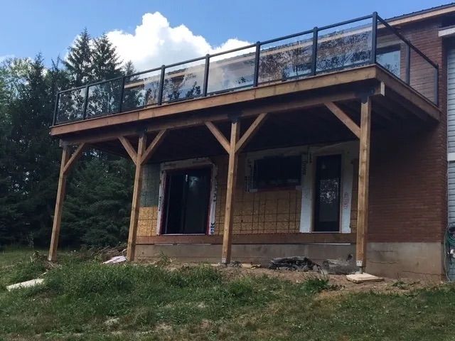 A brick house with a large deck on top of it
