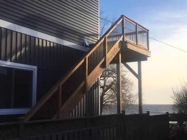 A wooden deck with stairs leading up to it