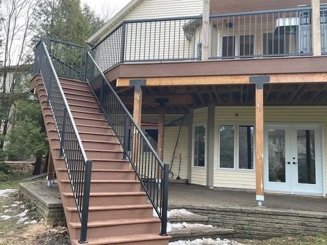 A house with a deck and stairs leading up to it