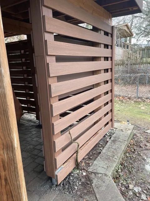 A wooden fence with a few holes in it