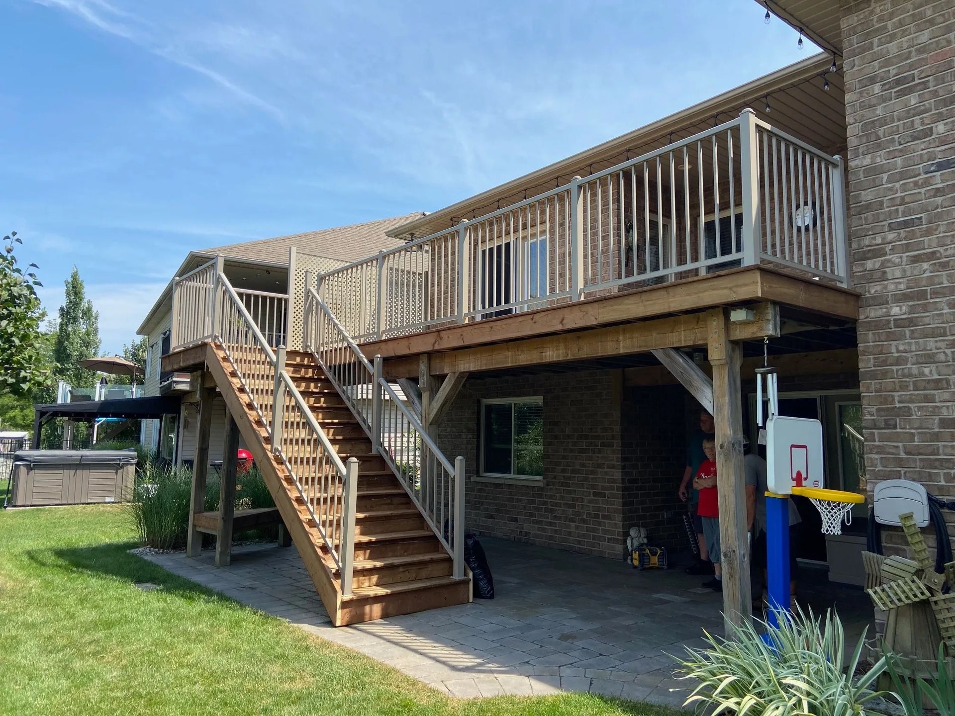 A house with a large deck and stairs leading up to it.