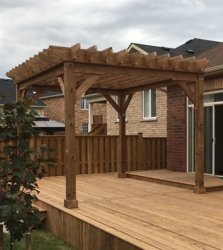 A wooden deck with a pergola on top of it