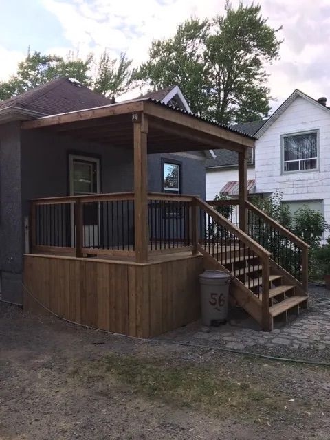 A wooden deck with stairs leading up to it