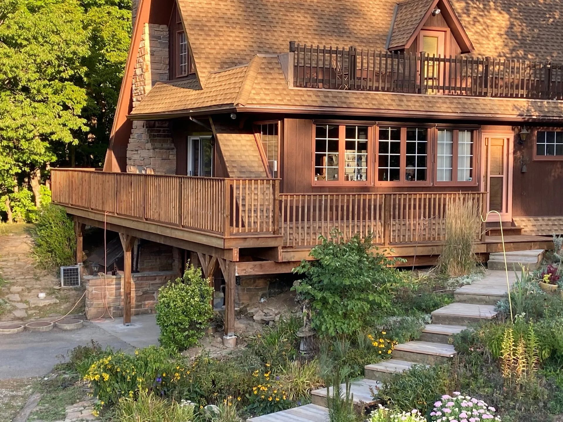 A large house with a large deck and stairs leading up to it.