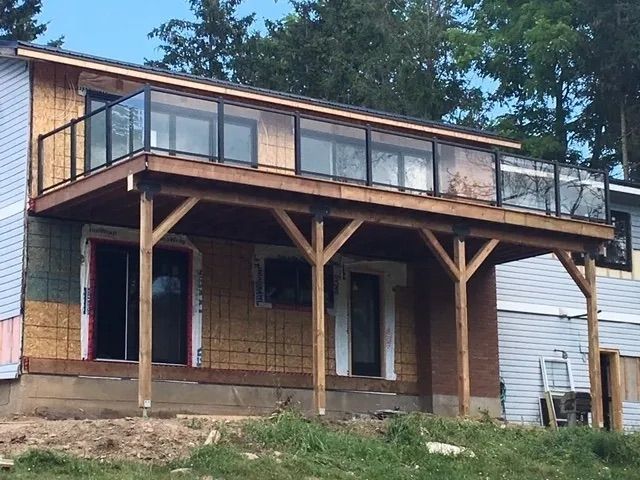 A house under construction with a large deck