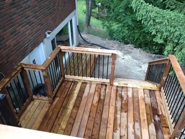 A wooden deck with stairs leading up to it