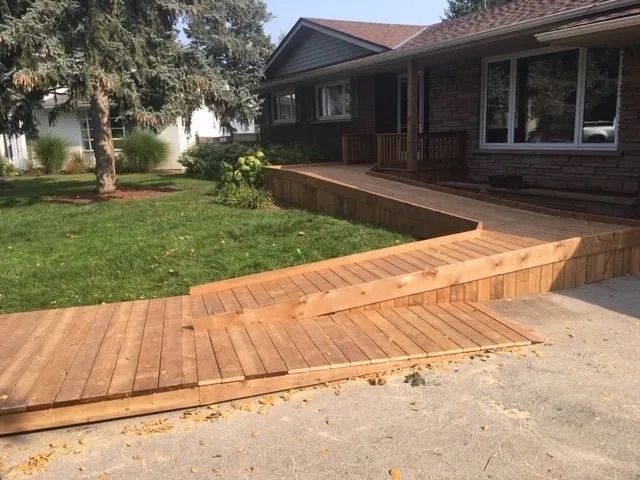 A wooden ramp is being built in front of a house.
