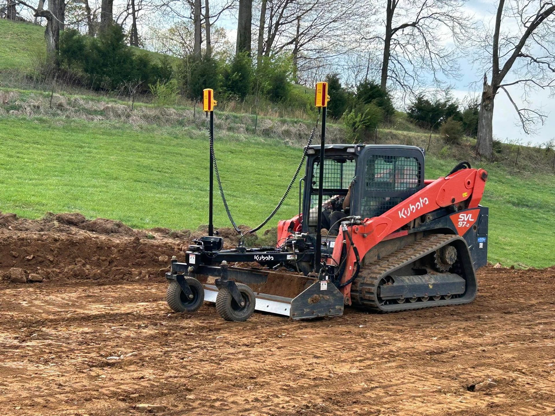 A bulldozer is sitting on top of a dirt field.