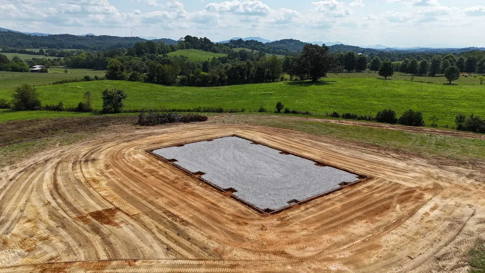 An aerial view of a dirt field with a large rectangle in the middle.