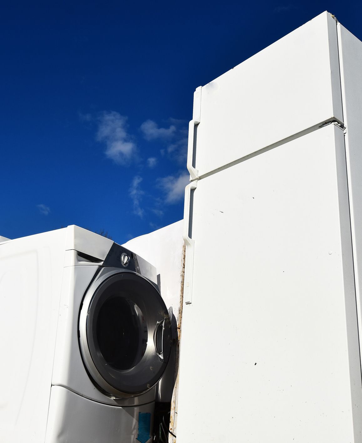 A washer and dryer are sitting next to a refrigerator