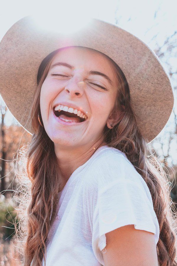 Beautiful Happy Young Woman Under the Sun — Teeth Whitening in Newcastle, NSW