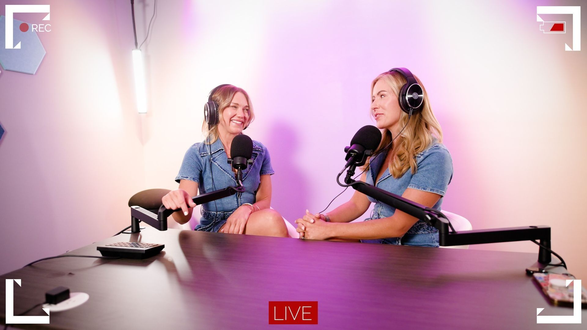 Two girls talking with headphones and microphones.