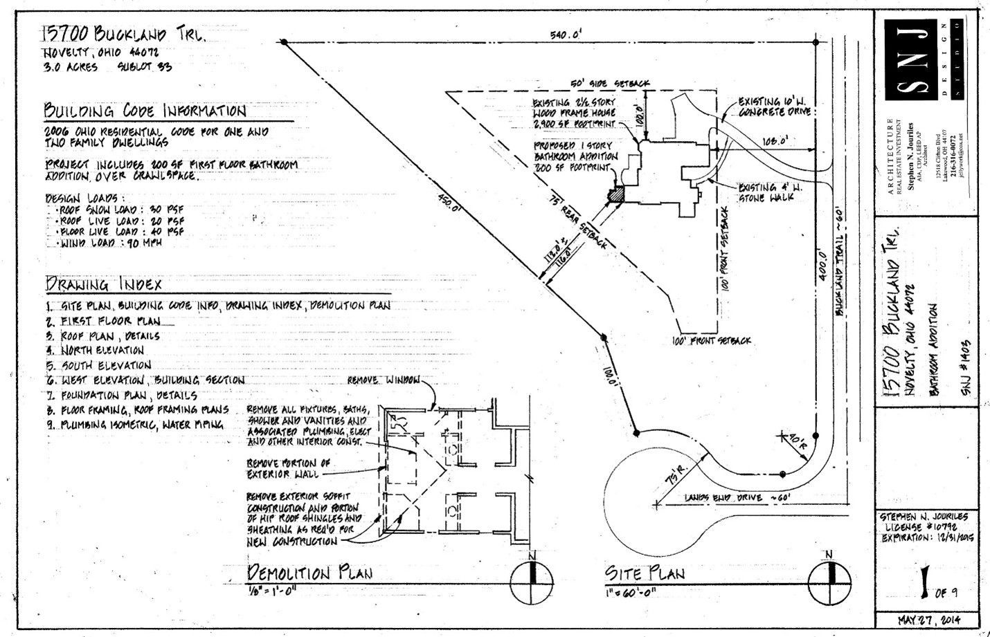 Mustard-colored two-story building with large storefront windows and bay windows on the second floor.
