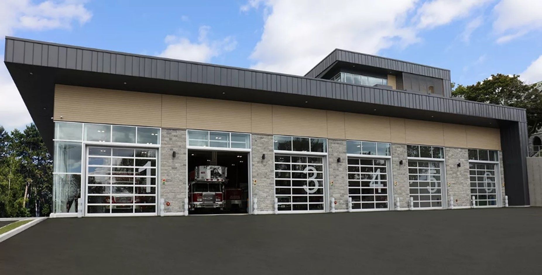 A large building with a lot of windows and a car parked in the garage.
