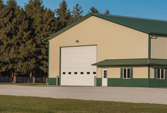 A large building with a green roof and a white garage door
