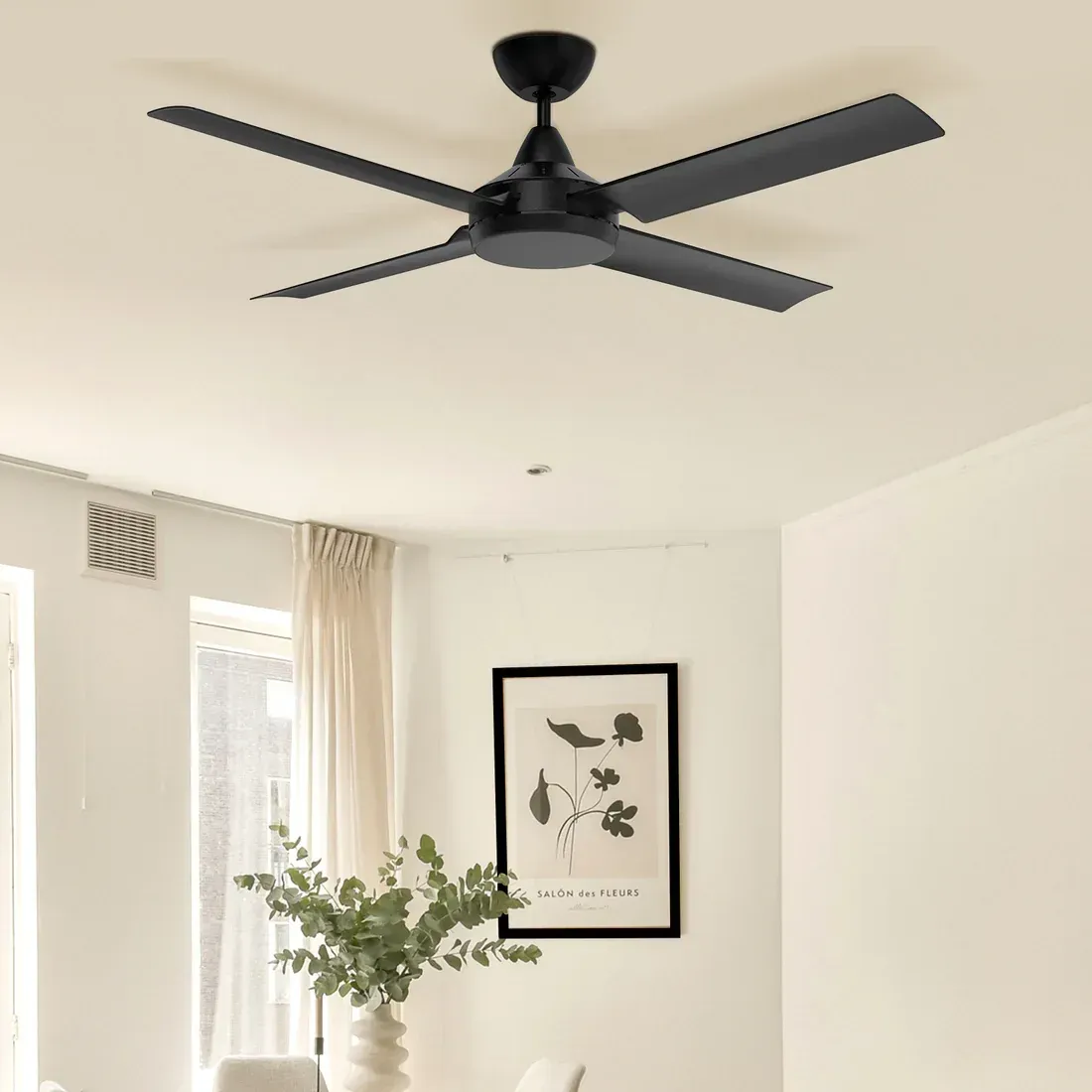 Black ceiling fan in a white room with a framed artwork. — Neave Electrical in Forster, NSW